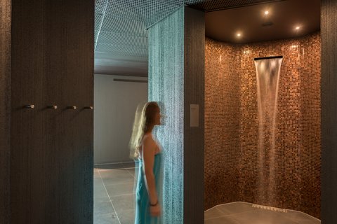 Woman at the experience shower of the wellnessHostel4000 in Saas-Fee.